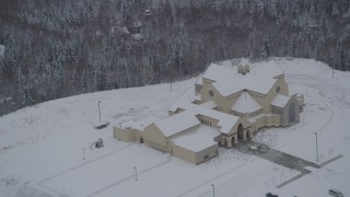 AK0001_1634 - 4K aerial stock footage approaching a church in snow covered Eagle River, Alaska