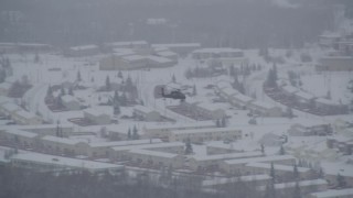 AK0001_1638 - 4K aerial stock footage helicopter flying over snow covered Fort Richardson, Anchorage, Alaska