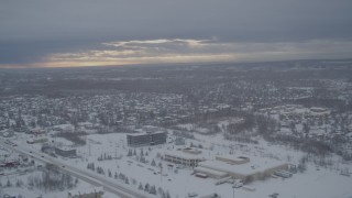 AK0001_1645 - 4K aerial stock footage flying by snow covered neighborhoods, mobile home park, Anchorage, Alaska
