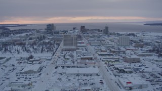 AK0001_1651 - 4K aerial stock footage flying over snow covered Downtown Anchorage at twilight, Alaska