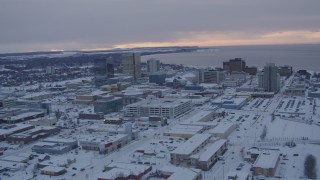 AK0001_1652 - 4K aerial stock footage flying over snow covered Downtown Anchorage at twilight, Alaska