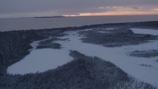 AK0001_1664 - 4K aerial stock footage Fire Island seen from snow covered Point MacKenzie at twilight, Alaska