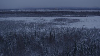 AK0001_1680 - 4K aerial stock footage a view of Downtown Anchorage seen from snowy Point MacKenzie at twilight, Alaska