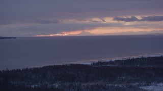 AK0001_1689 - 4K aerial stock footage twilight lit clouds over Cook Inlet seen from snow covered Point MacKenzie, Alaska