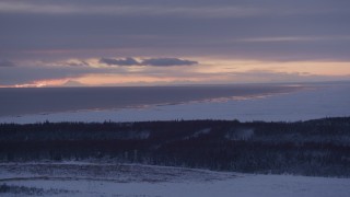 AK0001_1690 - 4K aerial stock footage twilight lit clouds over Cook Inlet seen from snow covered Point MacKenzie, Alaska
