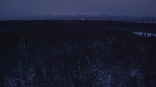 AK0001_1716 - 4K aerial stock footage revealing Downtown Anchorage skyline, winter, Point MacKenzie, Alaska, night