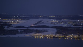 AK0001_1719 - 4K aerial stock footage snow covered Elmendorf Air Force Base at night, Anchorage, Alaska