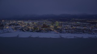 AK0001_1720 - 4K aerial stock footage snow covered Downtown Anchorage at night, Alaska