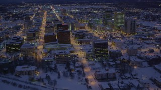 AK0001_1721 - 4K aerial stock footage fly over icy shore of Cook Inlet and snowy Downtown Anchorage, Alaska, night