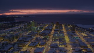 AK0001_1725 - 4K aerial stock footage a view of snow covered Downtown Anchorage at night, Alaska