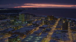 AK0001_1726 - 4K aerial stock footage flying over snow covered Downtown Anchorage at night, Alaska