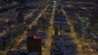 AK0001_1728 - 4K aerial stock footage flying over snow covered Downtown Anchorage at night, Alaska