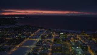 AK0001_1731 - 4K aerial stock footage sunset lit horizon seen from snow covered Downtown Anchorage at night, Alaska