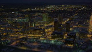 AK0001_1733 - 4K aerial stock footage flying by snow covered Downtown Anchorage at night, Alaska