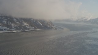 AK0001_1740 - 4K aerial stock footage fly through low clouds over snowy Turnagain Arm of the Cook Inlet, Alaska