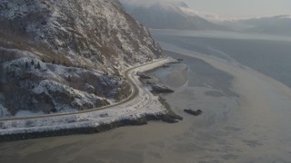 AK0001_1741 - 4K stock footage aerial video approaching Seward Highway on the snowy shore of the Turnagain Arm, Alaska