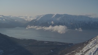 AK0001_1746 - 4K aerial stock footage snowy Kenai Mountains across from Turnagain Arm of the Cook Inlet, Alaska