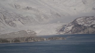 AK0001_1788 - 4K aerial stock footage a small, snow covered glacier spilling into the Harriman Fjord, Alaska