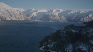 AK0001_1789 - 4K aerial stock footage fly along snowy shore of Harriman Fjord toward Chugach Mountains, Alaska