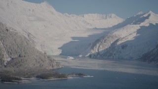 AK0001_1790 - 4K aerial stock footage snowy glacier spilling down Chugach Mountains into Harriman Fjord, Alaska