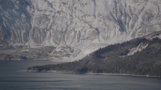 AK0001_1791 - 4K aerial stock footage flying away from a snow covered glacier spilling into the Harriman Fjord, Alaska