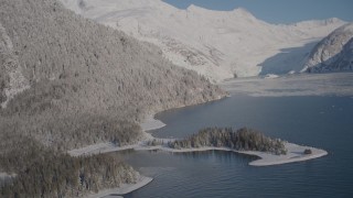 AK0001_1792 - 4K aerial stock footage descending toward surface of Harriman Fjord, past snowy slopes, Alaska