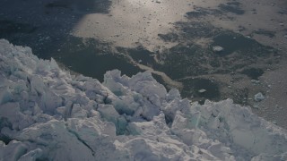 AK0001_1801 - 4K aerial stock footage bird's eye view of the jagged edge of a snow covered glacier on the Harriman Fjord, Alaska