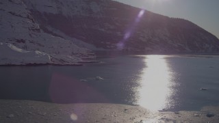 AK0001_1820 - 4K aerial stock footage the sun reflecting off water in Harriman Fjord near snow covered glacier, Alaska