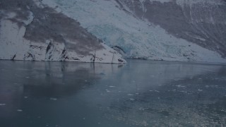 AK0001_1821 - 4K aerial stock footage flying low over surface of Harriman Fjord toward snow covered glacier, Alaska