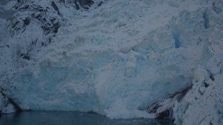 AK0001_1822 - 4K aerial stock footage the ragged edge of a snow covered glacier in Harriman Fjord, Alaska