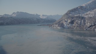 AK0001_1826 - 4K aerial stock footage flying over icy water in Harriman Fjord surrounded by snowy mountains, Alaska
