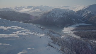 AK0001_1894 - 4K aerial stock footage flying over snow covered slopes near Pigot Bay, Alaska