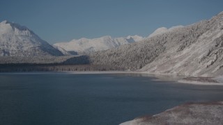 AK0001_1923 - 4K stock footage aerial video flying over Carmen Lake, snowy Chugach Mountains in the distance, Alaska