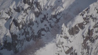 AK0001_1951 - 4K aerial stock footage a snowy ridge with mountain goats, Chugach Mountains, Alaska