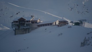 AK0001_1963 - 4K aerial stock footage flying away from snow covered ski lodge at summit, Girdwood, Alaska