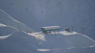AK0001_1967 - 4K aerial stock footage orbiting snow covered ski lift, revealing ski lodge, Girdwood, Alaska