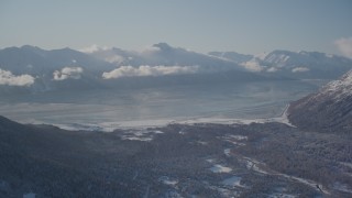 AK0001_1969 - 4K aerial stock footage the snow covered Kenai Mountains with low cloud cover, Girdwood, Alaska