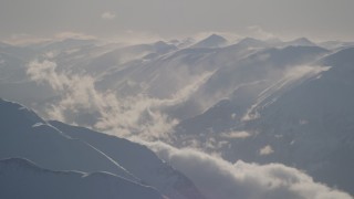AK0001_1981 - 4K aerial stock footage snow covered, windswept Kenai Mountains, Alaska