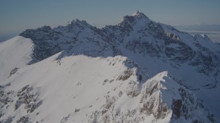 AK0001_1990 - 4K aerial stock footage flying over the snow covered Chugach Mountains, Alaska