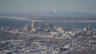 AK0001_2012 - 4K aerial stock footage flying toward snowy Downtown Anchorage, Knik Arm of the Cook Inlet, Alaska