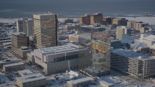 AK0001_2014 - 4K stock footage aerial videos tilting down on snow covered buildings in Downtown Anchorage, Alaska