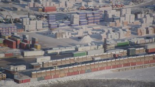 AK0001_2016 - 4K aerial stock footage forklift behind snow covered cargo containers at the Port of Anchorage, Alaska