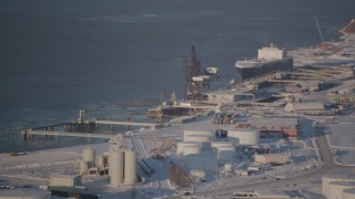 AK0001_2030 - 4K aerial stock footage a cargo ship docked at Port of Anchorage in snow, Alaska