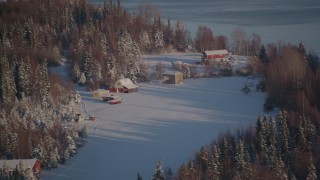 AK0001_2034 - 4K aerial stock footage cabins in snowy woods in Point MacKenzie, Alaska