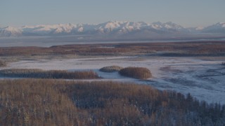 AK0001_2059 - 4K aerial stock footage snowy Chugach Mountains, woods, Big Lake Area, Knik-Fairview, Alaska