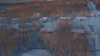 AK0001_2070 - 4K aerial stock footage flying over snow covered residential neighborhood in Wasilla at sunset, Alaska