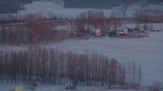 AK0001_2096 - 4K aerial stock footage passing a rural home with snow on the ground at twilight, Palmer, Alaska