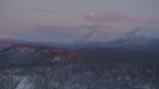 AK0001_2103 - 4K aerial stock footage snowy Chugach Mountains, moon, Matanuska River Valley, Alaska, twilight