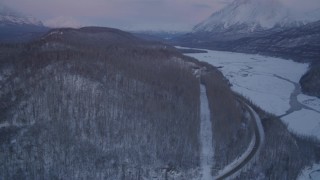 AK0001_2110 - 4K aerial stock footage reveal snowy Matanuska River Valley, Chugach Mountains at sunset, Alaska