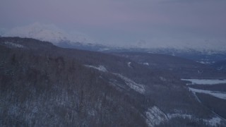 AK0001_2112 - 4K aerial stock footage snowy, forested hills, Matanuska River Valley, Chugach Mountains, Alaska, twilight 